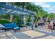 Outdoor lounge featuring a pergola with comfortable seating, picnic tables, and palm tree landscaping at 601 Mitchell Dr. # 806, Myrtle Beach, SC 29577