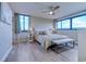 Bright main bedroom featuring a ceiling fan, bench, and ocean views at 601 Mitchell Dr. # 806, Myrtle Beach, SC 29577