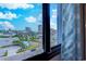 Stunning ocean view from the window, showcasing nearby buildings and palm trees under a blue sky at 601 Mitchell Dr. # 806, Myrtle Beach, SC 29577
