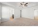Spacious bedroom with ceiling fan; door to bathroom on the left; entry and closet on the right at 610 Lightwood Dr., Conway, SC 29526