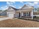 Inviting single-story home with brick accents, a two-car garage, covered porch, and manicured landscaping at 610 Lightwood Dr., Conway, SC 29526