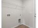 This practical laundry room includes hookups, shelving, and neutral paint at 614 Lightwood Dr., Conway, SC 29526