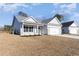 New home construction with neutral colors, green lawn, and large driveway at 618 Lightwood Dr., Conway, SC 29526