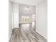 Inviting hallway with wood-look floors leading to a bright living area with large windows at 618 Lightwood Dr., Conway, SC 29526