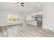 Open-concept living area with vaulted ceilings, wood-look floors, and bright kitchen at 618 Lightwood Dr., Conway, SC 29526