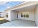 Covered outdoor patio with ceiling fan, windows, and a door to the backyard at 618 Lightwood Dr., Conway, SC 29526