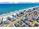 Stunning aerial view of beach houses along the coastline with the ocean in the background at 720 N Waccamaw Dr. # 202, Garden City Beach, SC 29576