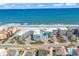 A captivating aerial showcases the condo complex, oceanfront location, and convenient parking at 720 N Waccamaw Dr. # 202, Garden City Beach, SC 29576