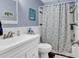 A well-lit bathroom with a single sink and decorated with beach themed accents at 720 N Waccamaw Dr. # 202, Garden City Beach, SC 29576