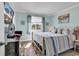 Calm bedroom with nautical accents, a comfortable bed, and sunny view from the window at 720 N Waccamaw Dr. # 202, Garden City Beach, SC 29576