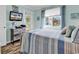 Bright bedroom with a cozy bed, television, and a balcony with outdoor furniture at 720 N Waccamaw Dr. # 202, Garden City Beach, SC 29576