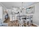 Casual dining area with seating for six, adjacent to a fully equipped kitchen and comfortable living space at 720 N Waccamaw Dr. # 202, Garden City Beach, SC 29576