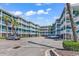 Brightly painted condominiums with white railings on the multiple decks offer coastal charm and curb appeal at 720 N Waccamaw Dr. # 202, Garden City Beach, SC 29576