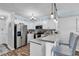 Inviting kitchen with granite countertops, stainless steel appliances, and bar seating for casual dining and entertaining at 720 N Waccamaw Dr. # 202, Garden City Beach, SC 29576