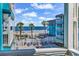 Beautiful ocean view from the property, showcasing the beach, palm trees, and relaxing lounge area at 720 N Waccamaw Dr. # 202, Garden City Beach, SC 29576