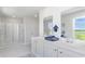 Bright bathroom featuring a double vanity with white countertops, a glass shower, and calming decor at 738 Chazen Way, Longs, SC 29568