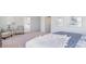 Comfortable bedroom with a queen bed, bedside tables, seating area, soft carpet, and large windows at 738 Chazen Way, Longs, SC 29568