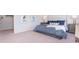 Calm bedroom features a queen bed with blue patterned bedding, side tables, and heron artwork on the walls at 738 Chazen Way, Longs, SC 29568