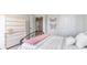 Bedroom features a white dresser, plush bedding, neutral walls, and butterfly artwork at 738 Chazen Way, Longs, SC 29568