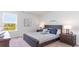 Charming bedroom featuring a dark wood bed frame and an outside view from the window at 738 Chazen Way, Longs, SC 29568