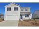 Charming two-story home with gray siding, black shutters, and a two-car garage on a sunny day at 738 Chazen Way, Longs, SC 29568