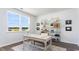 Bright home office with a classic desk, decorative shelving, and a view through a large window at 738 Chazen Way, Longs, SC 29568