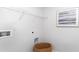 Bright laundry room features white walls, wire shelving, utility sink hookups, and modern art at 738 Chazen Way, Longs, SC 29568