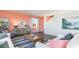 Comfortable living room with a coral accent wall, white sofa, a striped rug, and views of the neighborhood at 738 Chazen Way, Longs, SC 29568