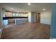 Open-concept living space highlighting a spacious kitchen with an island and wood-look flooring at 753 Wailea Circle, Little River, SC 29566