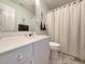 Clean bathroom featuring a white vanity, a shower with a striped curtain, and neutral decor at 75-4 Weehawka Way # 4, Pawleys Island, SC 29585