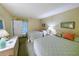 This is a cozy bedroom with two beds, lamps, framed art and carpeted floors at 75-4 Weehawka Way # 4, Pawleys Island, SC 29585