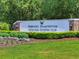 Community entrance sign amidst manicured lawns and lush greenery at 75-4 Weehawka Way # 4, Pawleys Island, SC 29585