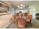 Cozy dining area with a glass-top table, wicker chairs, and a view into the kitchen at 75-4 Weehawka Way # 4, Pawleys Island, SC 29585
