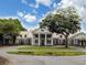 Elegant home exterior with a white facade, large pillars, and lush landscaping at 75-4 Weehawka Way # 4, Pawleys Island, SC 29585