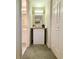 Narrow hallway between rooms with a mini-fridge and coffee maker under a wooden table at 75-4 Weehawka Way # 4, Pawleys Island, SC 29585