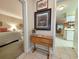 Interior hallway with tile floor, decorative table and wall art, leading to bedrooms and kitchen at 75-4 Weehawka Way # 4, Pawleys Island, SC 29585