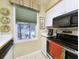 Bright kitchen featuring stainless steel appliances, white cabinetry, and a window with a pleasant view at 75-4 Weehawka Way # 4, Pawleys Island, SC 29585