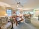 Cozy living room with ceiling fan, floral decor, and an open view to the kitchen and dining area at 75-4 Weehawka Way # 4, Pawleys Island, SC 29585