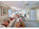 Inviting living room with ceiling fan, floral decor and a seamless view of the dining area and kitchen at 75-4 Weehawka Way # 4, Pawleys Island, SC 29585