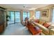 Comfortable living room features sliding glass doors to a patio, floral decor, and neutral carpeting at 75-4 Weehawka Way # 4, Pawleys Island, SC 29585