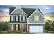 Charming two-story home featuring stone accents, a two-car garage, and beautifully landscaped front yard at 814 Belle Dr., North Myrtle Beach, SC 29582