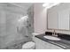 Modern bathroom with marble tile shower, glass door, dark counters and brushed metal fixtures at 8207 Timber Ridge Rd., Conway, SC 29526