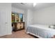 Sunlit bedroom featuring hardwood floors, a window overlooking the yard, and classic dresser at 8207 Timber Ridge Rd., Conway, SC 29526