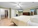 Spacious bedroom features a ceiling fan, wood floors, and an ensuite bathroom at 8207 Timber Ridge Rd., Conway, SC 29526