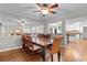 Open dining room features wood floors, a large dining table, and a mirrored wall at 8207 Timber Ridge Rd., Conway, SC 29526