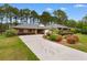 Beautiful one-story home features a long drive and inviting landscaping for curb appeal at 8207 Timber Ridge Rd., Conway, SC 29526