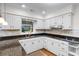 Well-maintained kitchen boasts white cabinets, granite countertops, and modern stainless steel appliances at 8207 Timber Ridge Rd., Conway, SC 29526