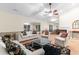 Large open living room features wood floors, classic furniture, and views to the backyard at 8207 Timber Ridge Rd., Conway, SC 29526