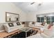Open living room with a high ceiling, wood floors, classic furniture, and views to the back yard at 8207 Timber Ridge Rd., Conway, SC 29526