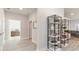 Bright hallway with luxury vinyl plank flooring and decorative shelving leading to additional rooms at 846 Ireland Dr., Longs, SC 29568